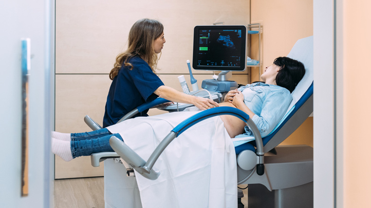 Female doctor performing a ultrasound to a patient