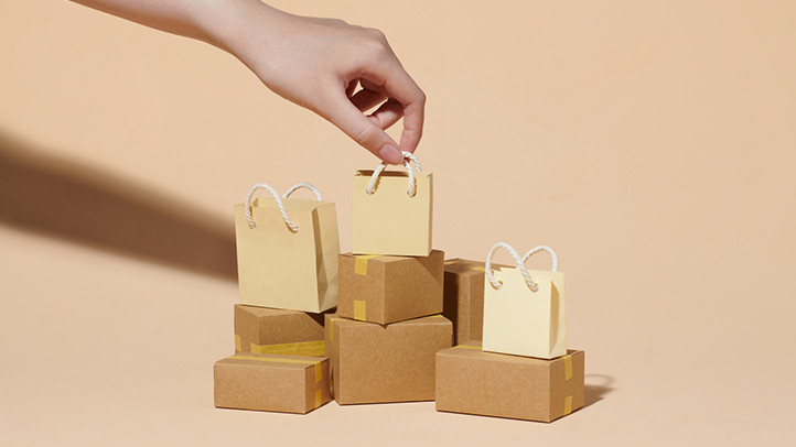 Amazon Prime Day Alternative Sales: Image of shopping bags stacked on top of cardboard boxes 