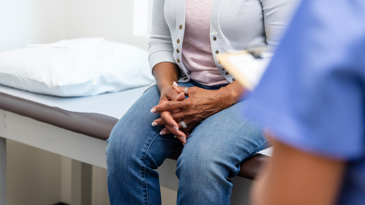 Unrecognizable woman talking to a doctor