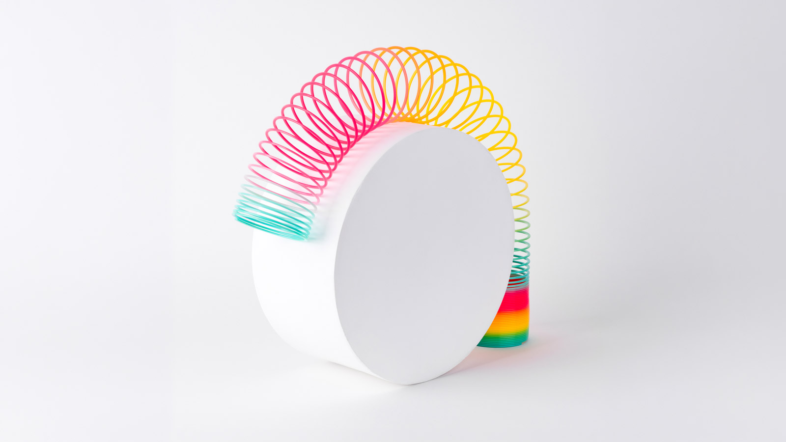 Round ligament pain, flexible multi-colored coil on cylinder on white background